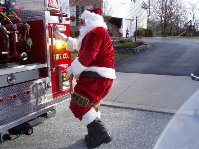 Santa has some trouble with his safety belt during the 2007 Santa run
